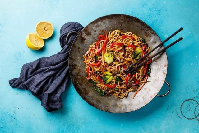 Udon stir fry noodles with oyster mushrooms and vegetables