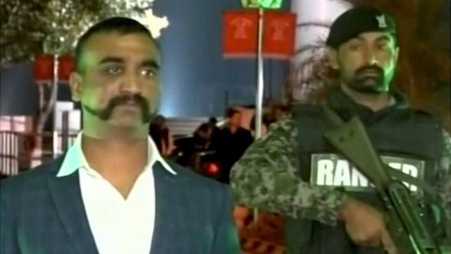 Indian pilot, Wing Commander Abhinandan, stands under armed escort near Pakistan-India border in Wagah