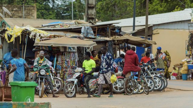 Group of men on motorbike waiting for customers