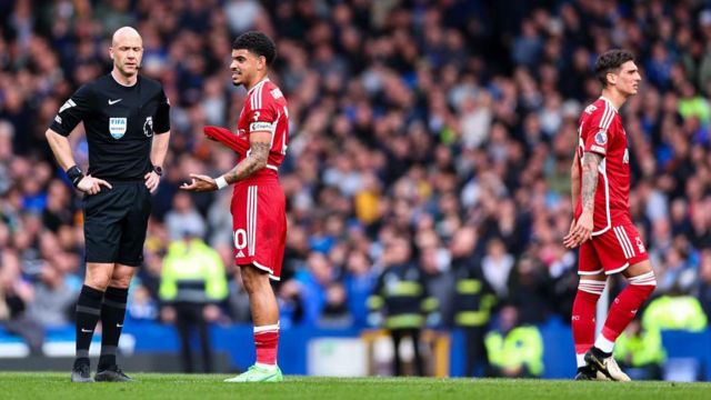 A dejected Morgan Gibbs-White of Nottingham Forest speaks to referee Anthony Taylor