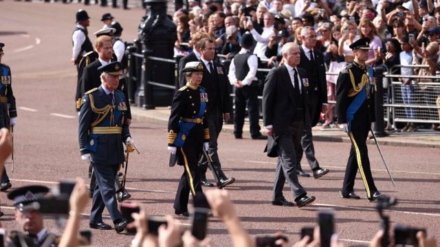 King Charles, Princess Anne, Prince Andrew and Prince Edward march during the procession of the coffin