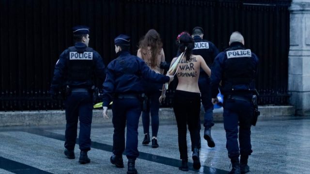 Femen protesters are taken away