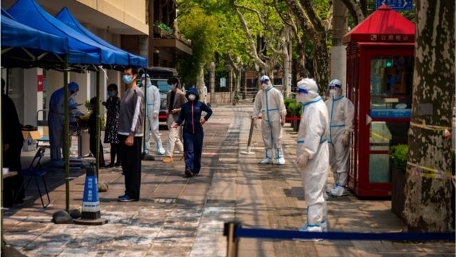 Public health officials in hazmat suits in Shanghai