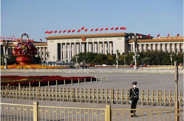 An armed policeman stands guard in Tiananmen Square before the opening ceremony of the 20th National Congress of the Communist Party of China on October 16