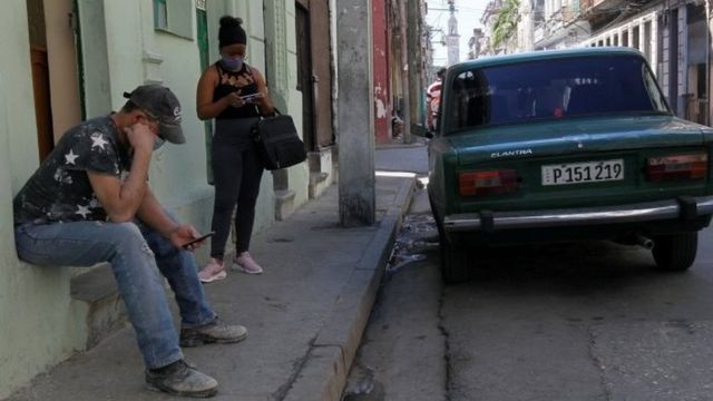 Cubans check their phones as telephone and internet connections were knocked out in a nationwide failure, in Havana, Cuba February 12, 2021