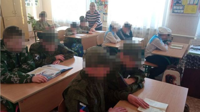 Ukrainian children wearing Russia military uniforms