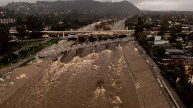 In an aerial view, the Los Angeles River flows at speed as a major storm hits the West Coast on January 5, 2023 in Los Angeles, California.