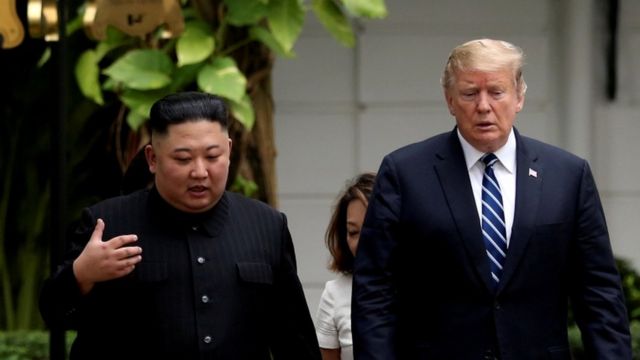 North Korea president Kim Jong-un and US president Donald Trump walking through the garden of the Metropole hotel during their summit on February 28