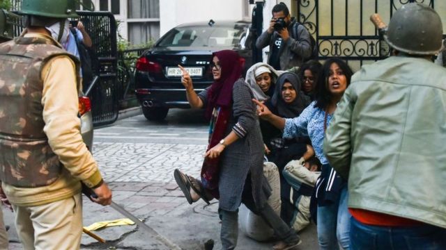 Students of Jamia Millia Islamia react during a protest against Citizenship Amendment Act