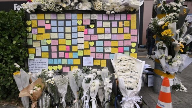 Flowers and messages at a makeshift memorial to the victims of the deadly Halloween escalation, outside a subway station in Itaewon.