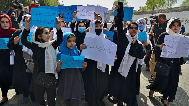 Mulheres e meninas afegãs participam de um protesto em frente ao Ministério da Educação em Cabul em 26 de março de 2022, exigindo que as escolas secundárias sejam reabertas para meninas.