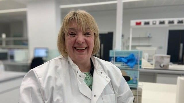 Sharon Quennell smiling during a tour of the cancer research centre