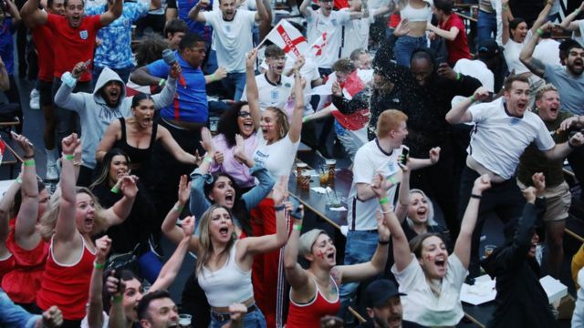 Soccer fans celebrate England's triumph over Denmark in the semi-finals.