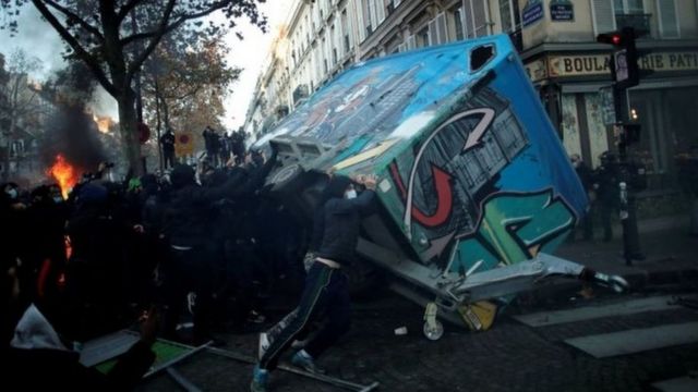 Protesters try to overturn a truck