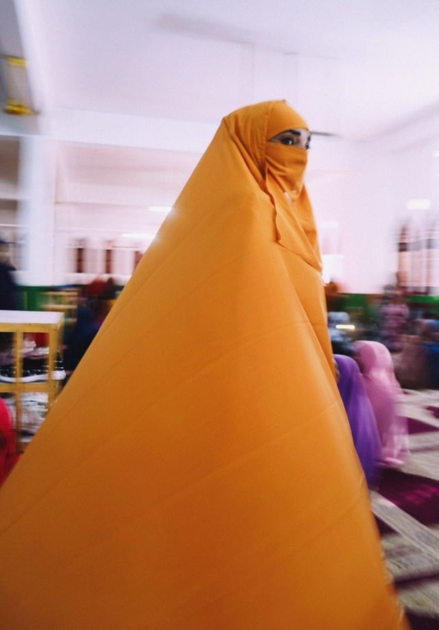 Woman wearing orange jilbab
