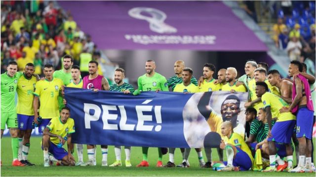 Brazil players pose with a banner dedicated to former Brazil player Pele during the FIFA World Cup Qatar 2022 Round of 16 match between Brazil and South Korea at Stadium 974 on December 05, 2022 in Doha, Qatar.