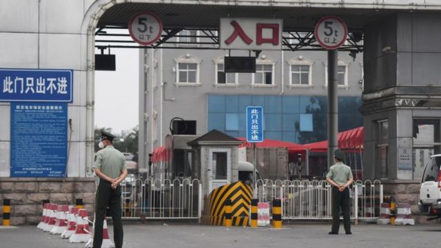 Chinese paramilitary police officers guard an entrance to the closed Xinfadi market in Beijing on June 13, 2020.