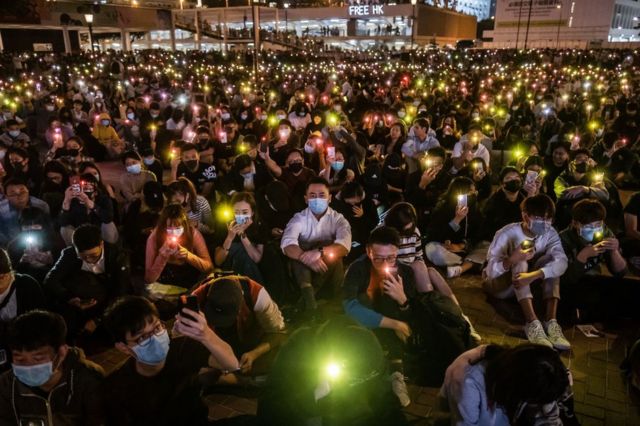 Demonstrators shine lights from smartphones during a rally at Edinburgh Place in the Central district of Hong Kong, China, on Thursday, Nov. 14, 2019.