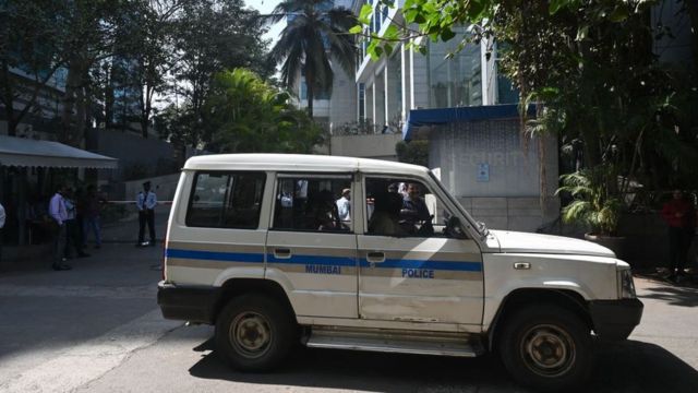 A police vehicle leaving the BBC's offices in Mumbai