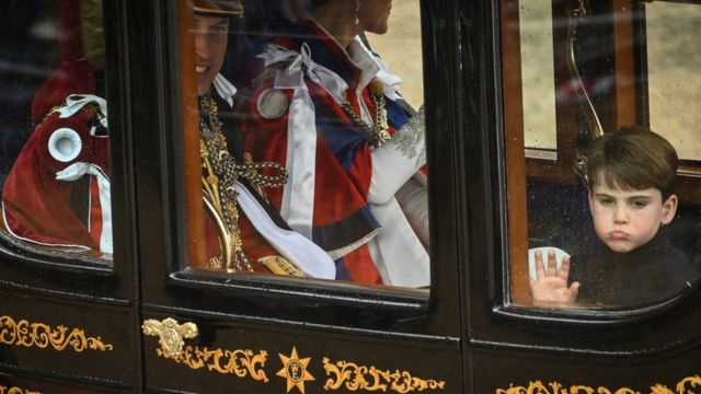 Prince William, Prince of Wales, Britain's Catherine, Princess of Wales and Britain's Prince Louis of Wales travel back to Buckingham Palace from Westminster Abbey in central London