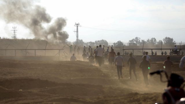 Palestinians break into the Israeli side of Israel-Gaza border fence after Palestinian gunmen infiltrated areas of southern Israel on Saturday 7 October 2023