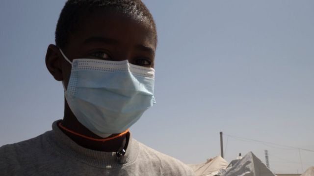 Young boy wearing a mask