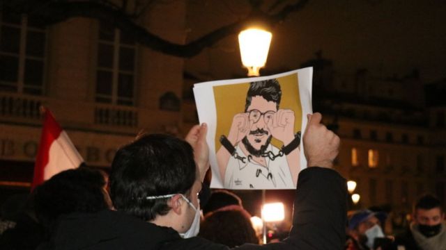 Protesters and human rights activists in Paris gather outside the National Assembly to protest against Sisi's visit and the warm welcome he received.  December 8, 2020.