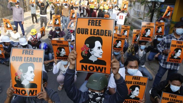 Protesters hold up placards demanding the release of detained Myanmar civilian leader Aung San Suu Kyi