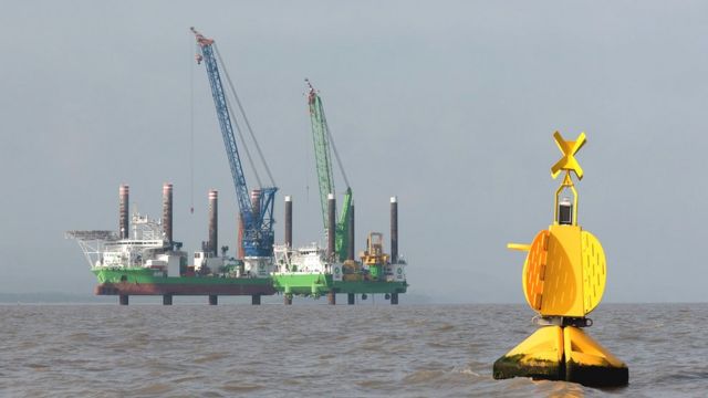 Two large platforms in the Bristol Channel off Hinkley Point C along with a floating buoy