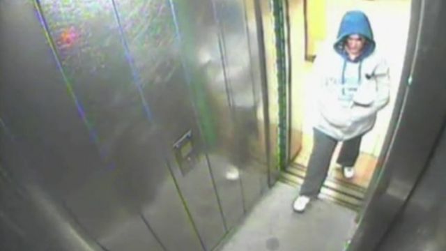 Security camera image shows a woman in a hood in an elevator