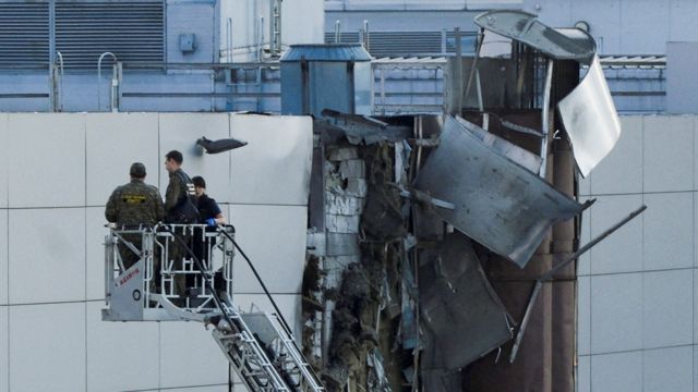 Repair teams inspecting the damaged building