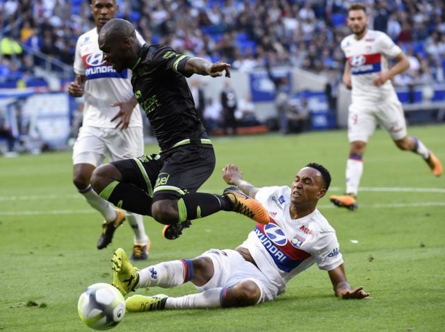 Guingamp"s French-Congolese defender Jordan Ikoko (L) vies with Lyon"s Dutch defender Kenny Tete (bottom) during the French L1 football match Lyon (OL) vs Guingamp (EAG), on September 10, 2017 at the Groupama stadium in DÃ©cines-Charpieu near Lyon, southeastern France.