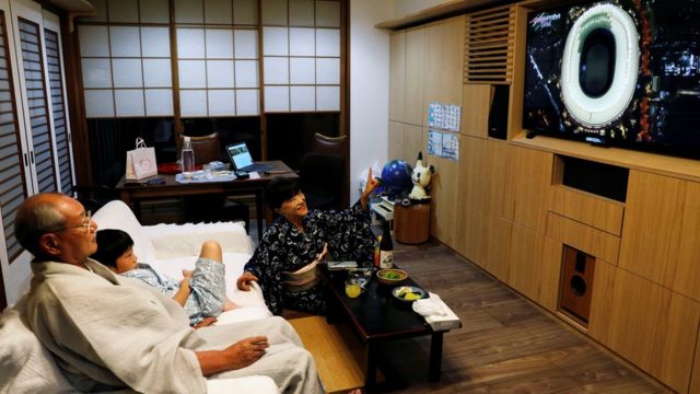 أسرة يابانية تشاهد حفل الافتتاح عبر التلفزيون