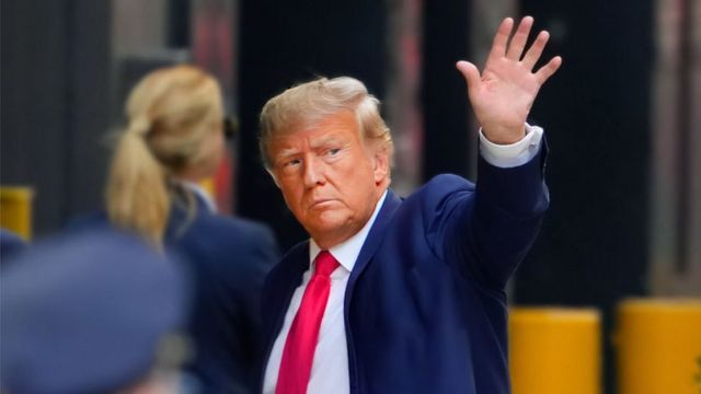 Donald Trump waves as he arrives at Trump Tower on Monday