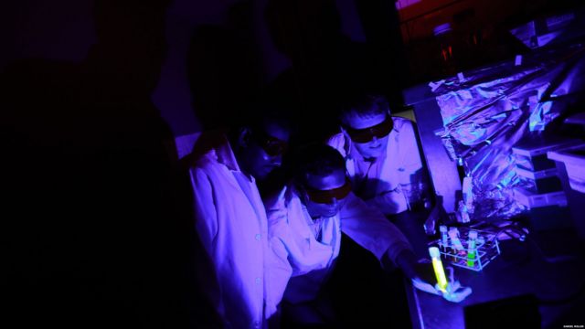 Dr. Ajith Karunarathne, Dr. John Payton and graduate student Kasun Ratnayake are examining reactions between blue light and retinal in a light proof laboratory at the University of Toledo