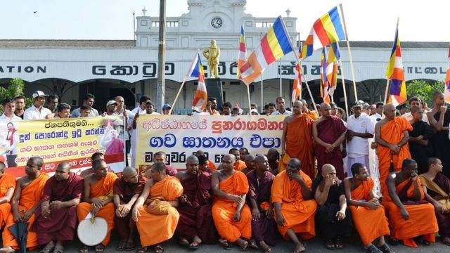 Sri Lankan protesters led by Sinhala Ravaya Buddhist monks take part in a demonstration outside the main railway station in the capital Colombo on February 16, 2014. The protesters were demanding the government prohibit the slaughter of cattle . AFP PHOTO/Ishara S. KODIKARA (Photo credit should read Ishara S.KODIKARA/AFP via Getty Images)