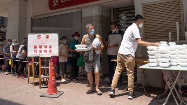 A group of senior citizens in Hung Hom, Kowloon, Hong Kong queue up to receive free lunch boxes distributed by volunteers (11/9/2022)