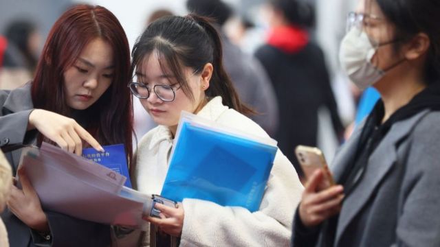 根据中国教育部，2023年全国高校毕业生预计达到1158万人，而2000年仅为100万人。(photo:BBC)