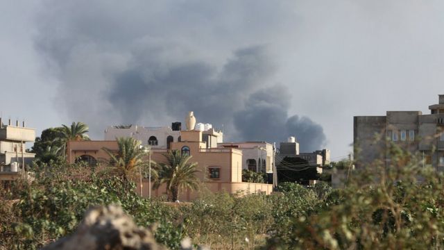 Smoke rises during heavy clashes between rival factions in Libya's Tripoli, 28 August 2018