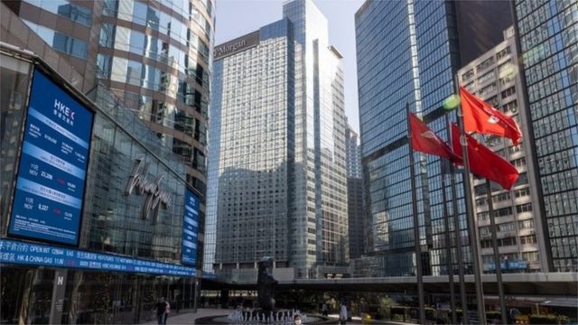 Electronic billboards display stock transactions on Exchange Square, the building housing the bourse, in Hong Kong, China, 30 November 2021.