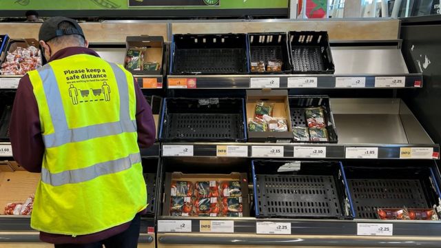 Sainbury's supermarket staff checks fruit and vegetable stocks are running out in London