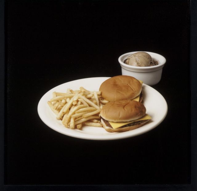 A meal featuring two burgers, french fries and ice cream