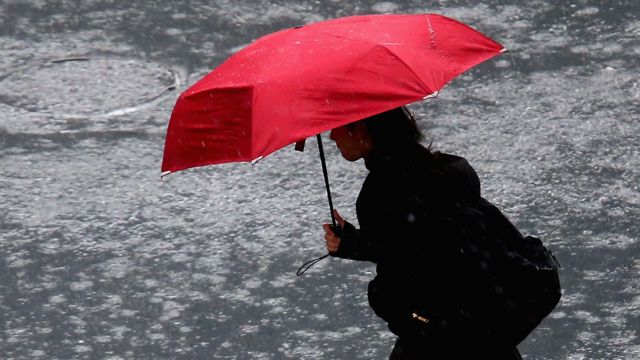 A woman walks in rain in Auckland