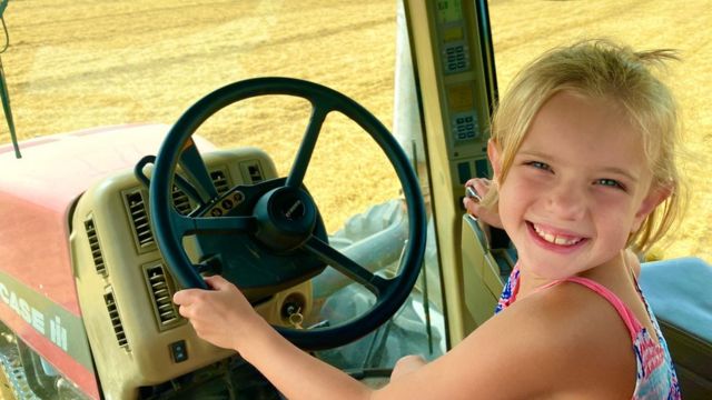 Katy Schultz's daughter drives a tractor