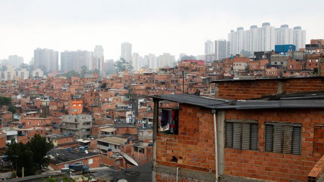 Houses in Paraisópolis, with buildings in the background