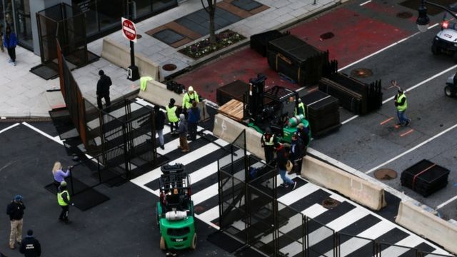 Workers place barricades to control access ahead of US President-elect Joe Biden's inauguration, in Washington, DC