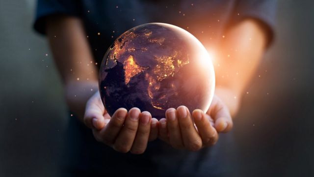 Earth being held in human hands