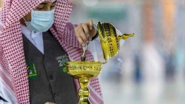 A handout picture provided by the Saudi ministry of media shows a member of the hajj staff burning incense at the Grand Mosque in the holy city of Mecca on 26 July 2020