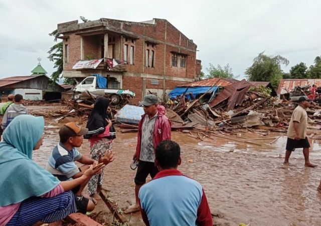 A handout photo made available by East Adonara Police station shows people gathering after a flash flood hit their village in Adonara, East Flores, Indonesia, 04 April 2021