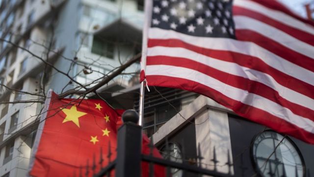 American and Chinese flags together in front of an international school in Beijing